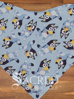 Italian greyhound dog wearing a purple poppy patterned ANZAC memorial bandana with 'Sacred Pet Boutique' watermark.