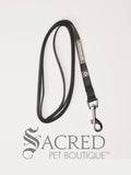 The Catventure logo and recycled image is shown on the black leash near the stainless steel snap hook end of the leash. The leash is shown looped and on a white background.