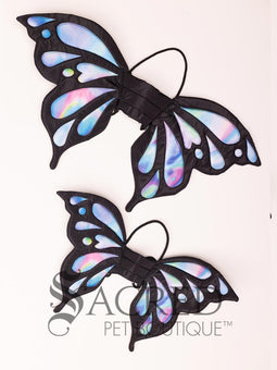The Small size black bat costume wings sit on a white background. A loop at the top goes over the dogs head allowing the wings to sit over the dogs shoulders or wherever you think it looks best. The tails of the loop allow the head loop to be pulled longer or shorter and can then be tied under the dogs belly, or around its harness.