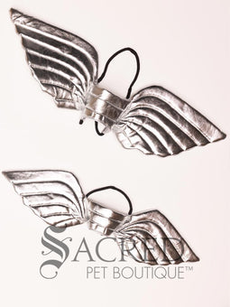 The Small size black bat costume wings sit on a white background. A loop at the top goes over the dogs head allowing the wings to sit over the dogs shoulders or wherever you think it looks best. The tails of the loop allow the head loop to be pulled longer or shorter and can then be tied under the dogs belly, or around its harness.