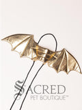 The Large size gold dragon costume wings sit on a white background. A loop at the top goes over the dogs head allowing the wings to sit over the dogs shoulders or wherever you think it looks best. The tails of the loop allow the head loop to be pulled longer or shorter and can then be tied under the dogs belly, or around its harness.