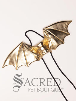 The Small size black bat costume wings sit on a white background. A loop at the top goes over the dogs head allowing the wings to sit over the dogs shoulders or wherever you think it looks best. The tails of the loop allow the head loop to be pulled longer or shorter and can then be tied under the dogs belly, or around its harness.