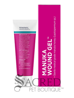 A tube and box of paw Manuka Wound Gel shown on a white background, featuring a golden retriever on the packaging. A 'SACRED PET BOUTIQUE' watermark is visible at the bottom.