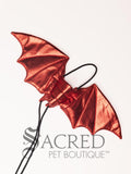 The Large size red dragon costume wings sit on a white background. A loop at the top goes over the dogs head allowing the wings to sit over the dogs shoulders or wherever you think it looks best. The tails of the loop allow the head loop to be pulled longer or shorter and can then be tied under the dogs belly, or around its harness.