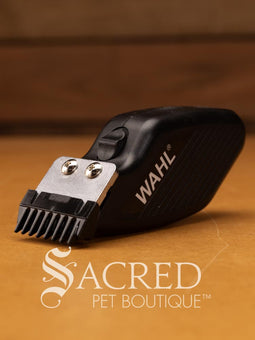 Wahl Pocket Pro trimmer kit in packaging, featuring a small black battery operated trimmer with the Wahl brand logo, a blade, and a blade guard. Features Sacred Pet Boutique watermark.
