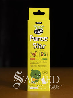 Four Yumguard Puree Star pet treats in different flavours (Fish and Mango, Chicken and Papaya, Fish and Apple, Chicken and berries) in colourful packaging, displayed on a wooden surface against a black background. With a white Sacred Pet Boutique watermark.