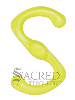Two dogs running and playing with a green floating toy in an outdoor grassy area. With a grey Sacred Pet Boutique watermark.