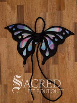 The Small size black bat costume wings sit on a white background. A loop at the top goes over the dogs head allowing the wings to sit over the dogs shoulders or wherever you think it looks best. The tails of the loop allow the head loop to be pulled longer or shorter and can then be tied under the dogs belly, or around its harness. 