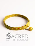 Lime Yellow patterned cat collar with a matching breakaway clip and bell on a white background, branded as Sacred Pet Boutique.