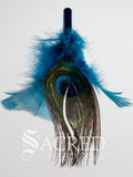 The end of the tie on replacement cat toy is shown on a plain white background. The Feathers are blue and in the centre is a peacock eye feather.