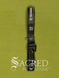 A dark green cat leash with a metal clip, shown vertically on a textured olive green background. A large 'Sacred Pet Boutique' watermark is visible at the bottom.