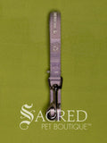 A lavender/lilac purple cat leash with a silver metal clip, shown vertically on a textured olive green background with a 'Sacred Pet Boutique' watermark at the bottom.