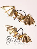 A pair of gold dragon costume wings sit on a white background. The comparison in sizes shows the large to be suitable for small to medium dogs and the small to for small to toy dogs.