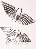 A pair of silver angel costume wings sit on a white background. The comparison in sizes shows the large to be suitable for small to medium dogs and the small to for small to toy dogs.