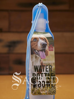 Pet water bowl with bottle attachment on a wooden surface, branded 'Sacred Pet Boutique'.