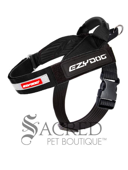 A black Express Harness is shown against a white background with a dark grey watermark. The front chest strap and the girth straps are adjustable. There is a control handle and sliding leash attachment point. The velcro name tag is the standard Ezydog name tag that comes with every Express harness