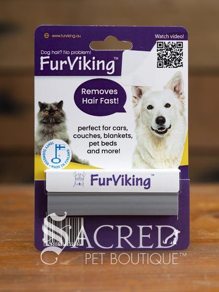 FurViking pet hair removal tool with packaging with a dog and cat images on a wooden surface
