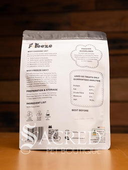 A packet of Freeze dried Tasmanian possum meat sits on a wooden table with a wood plank background. A clear window in the pack shows the pieces to be approximately 2 to 4 cm pieces.