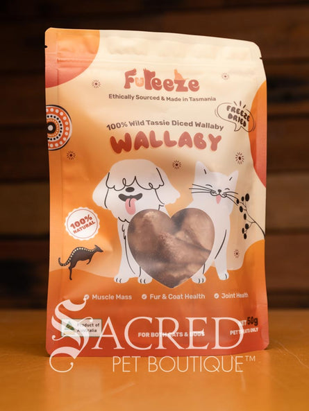 Freeze dried wallaby pieces can be seen through a clear window in the orange packaging of the Fureeze brand of products. The pack sits on a wooden table with a wood plank background.