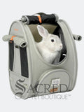 Ibiyaya Adventure cat Pet carrier with a rabbit peeking out, with a visible Sacred Pet Boutique watermark on a white background 
