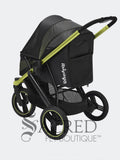 A black dog jogging stroller with lime green accents and a black canopy, shown from the rear, on a white background with a 'SACRED PET BOUTIQUE' watermark at the bottom.