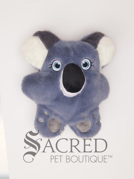 The super cute KONG Snuzzles plush toy is a blue grey colour, with grey and white ears and a big black nose. Eyes, mouth and paw pads are embroidered on for safety. It has pretty blue eyes. It is on a plain white background.