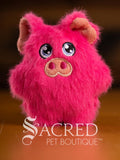 Pink plush squeaky pig toy with 'Sacred Pet Boutique' logo on a brown background