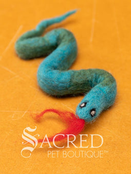 A pile of colourful wool felt balls with polka dots sits on a wooden table. Suitable for all cats and small to teacup sized dogs.