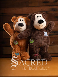 Two plush bears with a wooden background and 'Sacred Pet Boutique' branding.