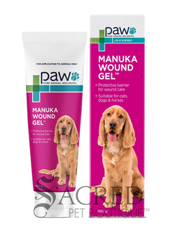 A tube and box of paw Manuka Wound Gel shown on a white background, featuring a golden retriever on the packaging. A 'SACRED PET BOUTIQUE' watermark is visible at the bottom.