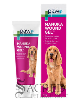 A tube and box of paw Manuka Wound Gel shown on a white background, featuring a golden retriever on the packaging. A 'SACRED PET BOUTIQUE' watermark is visible at the bottom.