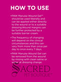 A bright pink informational graphic with the heading 'HOW TO USE' in white, followed by three paragraphs of white text about applying and cleaning PAW Manuka Wound Gel. The Sacred Pet Boutique logo appears at the bottom in dark grey.