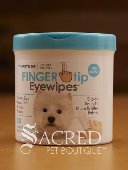 A container of Pekin Fingertip Eye Wipes for pets, with a blue lid and a label featuring a white dog. The container is labeled with the product name and highlights that it is formulated for cats and dogs, silicone-free, and features a micro bristle fabric. Features a Sacred Pet Boutique watermark.