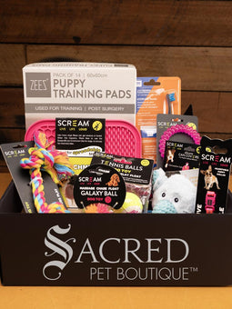 The gift pack is shown opened with the full selection of products on show. All pink or pink based items for female puppies.