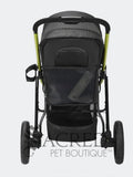 A black pet stroller with lime green frame accents, shown from the back against a white background. The stroller features a mesh canopy, a storage pocket, a drink holder, and a lower storage basket.