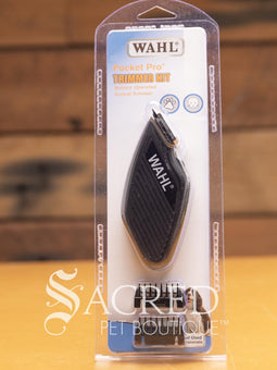 Wahl Pocket Pro trimmer kit in packaging, featuring a small black battery operated trimmer with the Wahl brand logo, a blade, and a blade guard. Features Sacred Pet Boutique watermark.
