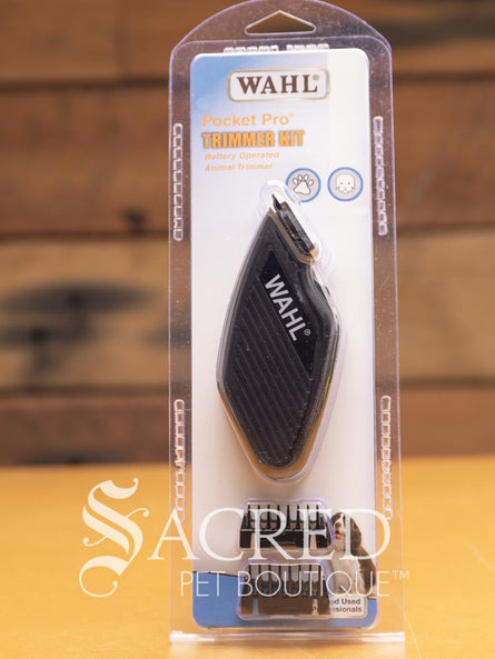 Wahl Pocket Pro trimmer kit in packaging, featuring a small black battery operated trimmer with the Wahl brand logo, a blade, and a blade guard. Features Sacred Pet Boutique watermark.