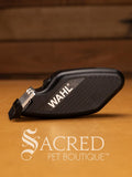 Wahl Pocket Pro trimmer on wooden background and features Sacred Pet Boutique watermark.