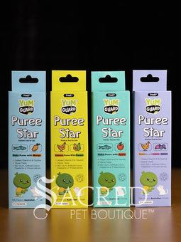 Four Yumguard Puree Star pet treats in different flavours (Fish and Mango, Chicken and Papaya, Fish and Apple, Chicken and berries) in colourful packaging, displayed on a wooden surface against a black background. With a white Sacred Pet Boutique watermark.
