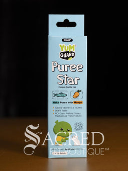 Four Yumguard Puree Star pet treats in different flavours (Fish and Mango, Chicken and Papaya, Fish and Apple, Chicken and berries) in colourful packaging, displayed on a wooden surface against a black background. With a white Sacred Pet Boutique watermark.