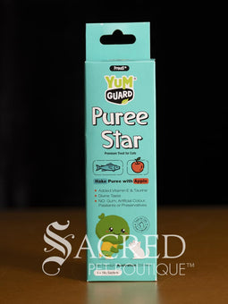 Four Yumguard Puree Star pet treats in different flavours (Fish and Mango, Chicken and Papaya, Fish and Apple, Chicken and berries) in colourful packaging, displayed on a wooden surface against a black background. With a white Sacred Pet Boutique watermark.