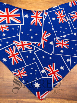 Italian greyhound dog wearing a purple poppy patterned ANZAC memorial bandana with 'Sacred Pet Boutique' watermark.