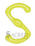 A bright green dog toy in a distinctive S shape and has a slightly textured, matte finish and includes a small circular emblem stamped in the centre with a dog paw print. It's lying on a white background with a grey Sacred Pet Boutique watermark at the bottom of the image. 