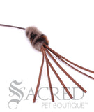 The end of a Purrfect Leather Bouncer cat teaser toy is shown on a plain white background. A fake fur body looks like a mouse. There are six leather tassel tails that will intrigue your kitty. 