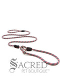 A red/black rope leash with a metal slider and rubber stoppers, Ezydog Luca leash can be used as a "slip" leash. White background with 'SACRED PET BOUTIQUE' watermark.