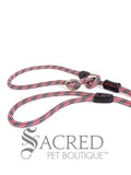 A red/black rope leash with a metal slider and rubber stoppers, Ezydog Luca leash can be used as a "slip" leash. White background with 'SACRED PET BOUTIQUE' watermark.