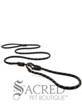 A black/grey rope leash with a metal slider and rubber stoppers, Ezydog Luca leash can be used as a "slip" leash. White background with 'SACRED PET BOUTIQUE' watermark.