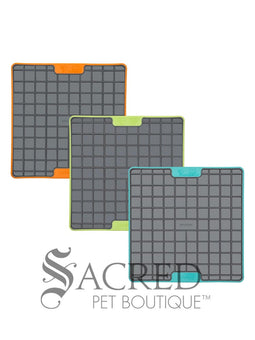 Three LickiMat Tuff Buddy mats in three different colours - orange, green and blue. They're on a white background and has a grey Sacred Pet Boutique watermark. 