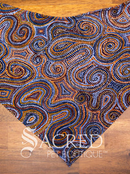Dog wearing a purple poppy patterned ANZAC memorial bandana with 'Sacred Pet Boutique' logo.
